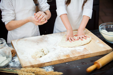 Obraz na płótnie Canvas two girls make flour dough.