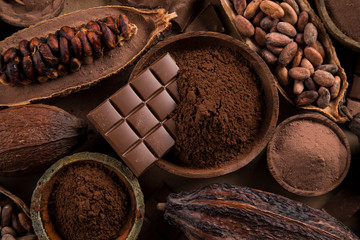 Cocoa beans and chocolate on natural paper background