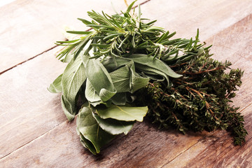 Homegrown and aromatic herbs on rustic background with rosemary and basil