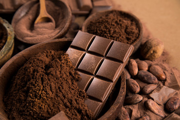 Cocoa beans and chocolate on natural paper background