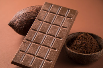 Cocoa beans and chocolate on natural paper background