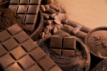 Cocoa beans and chocolate on natural paper background
