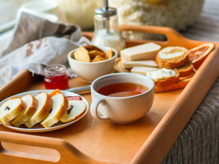 cornflakes, coffee, cottage cheese, bread, butter, eggs, jam and other ingredients for breakfast on a dark background. Top view with copy space