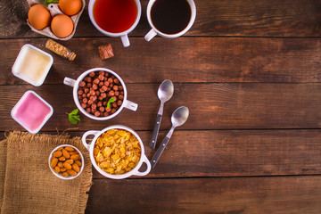 cornflakes, coffee, cottage cheese, bread, butter, eggs, jam and other ingredients for breakfast on...