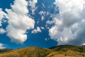 Spring time panoramic landscape from Old mountain, Bulgaria. Blue sky with white puffy clouds