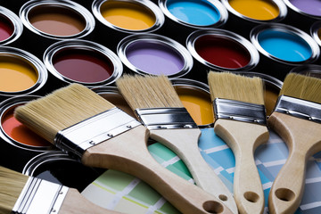 Tin cans with paint and brushes
