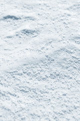 Fresh snow background texture. Winter background with snowflakes and snow mounds. Snow lumps.