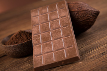 Cocoa beans and chocolate on natural paper background