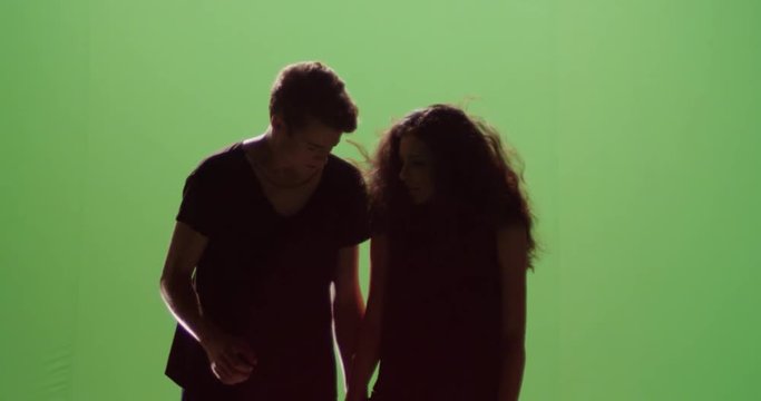 Distressed couple woman and man hiding from explosion slow motion against green screen