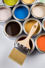 Metal tin cans with color paint and paintbrush