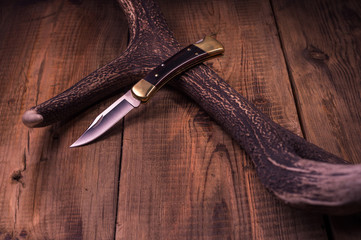 Knife in frame. Folding hunting knife. Cowboy knife.