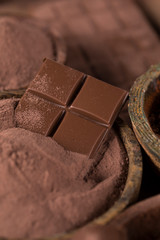 Cocoa beans and chocolate on natural paper background