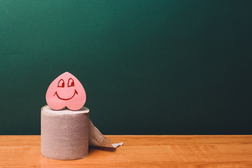 Roll of toilet paper with a smiling heart. Digestion Concept.