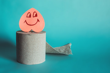 Roll of toilet paper with a smiling heart. Digestion Concept.