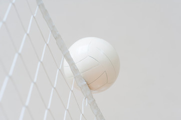 Volleyball ball over the net during match
