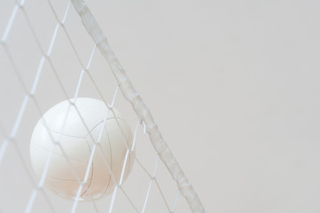 Volleyball ball over the net during match