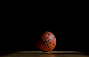 Basketball ball on the parquet with black background