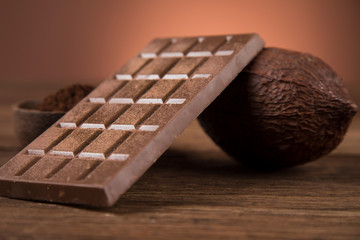 Cocoa beans and chocolate on natural paper background