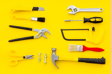 instruments of constructor for build, paint and repair house on yellow background top view pattern