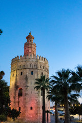 Fototapeta na wymiar The Golden Tower (Torre del Oro) in Seville, Spain, is located at the margin of the Guadalquivir river and was built in the XIII century by the muslims ruling the area at the time.