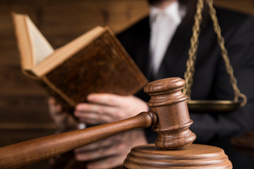 Judge, male judge in a courtroom striking the gavel