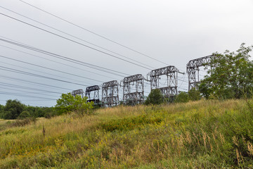 Fototapeta na wymiar High voltage power lines towers on Khortytsia island, Ukraine.