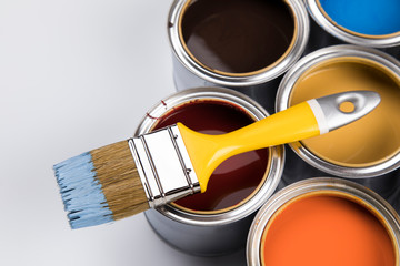 Metal tin cans with color paint and paintbrush