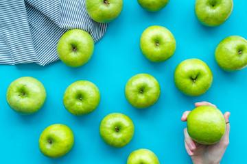 green apples for organic summer food pattern on blue background top view