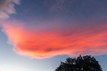 Reddish clouds at sunset over mountains