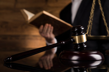 Judge, male judge in a courtroom striking the gavel