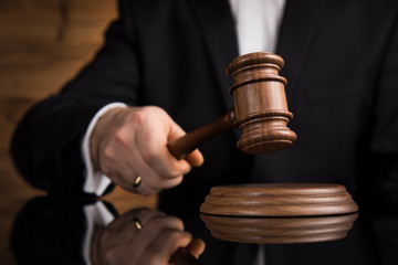 Judge, male judge in a courtroom striking the gavel