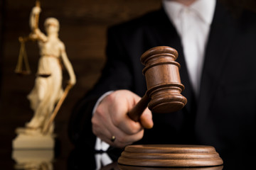 Judge, male judge in a courtroom striking the gavel