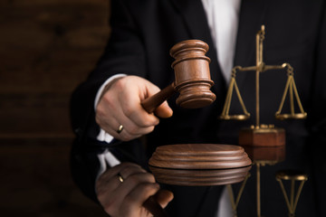 Judge, male judge in a courtroom striking the gavel