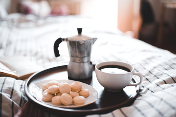 Mug of coffee with cookies on plate in room closeup. Good morning.