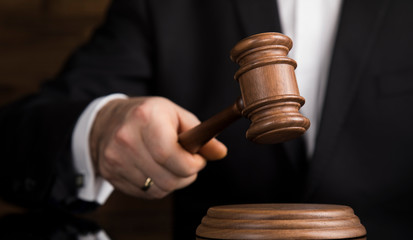 Judge, male judge in a courtroom striking the gavel