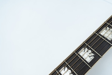 Fototapeta na wymiar Acoustic guitar neck in the right-down corner on white background
