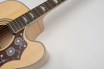 Obraz premium Fretboard and soundboard of an acoustic guitar on white background. Close-up, perspective