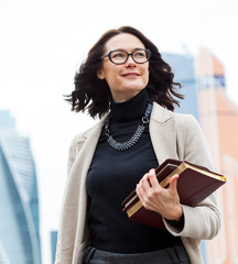 smiling middle-aged woman with books