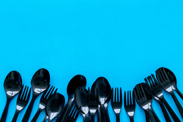 Plastic utilization concept with flatware on blue background top view mock up