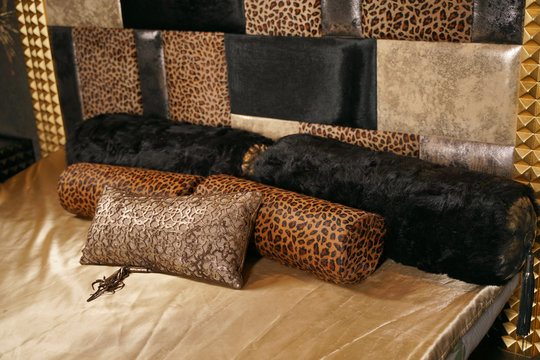 Luxury Gold With Black Bedroom Interior With Leopard Print. Rich Big Bed With Pillows.