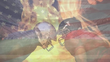 Rugby players standing head to head with animated fire burning and American flag waving on the backg - Powered by Adobe
