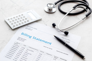 medical treatment bill, calculator and phonendoscope on white background