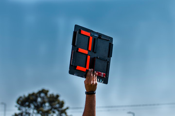 Assistant Football referee shows extra time