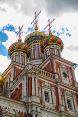 Fototapeta na wymiar Ancient Orthodox church with multi-colored carved domes and carved patterns in the city of Nizhny Novgorod (Russia)