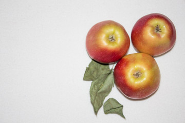apples with leaves on white background