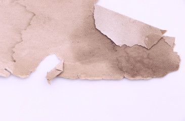 The texture of the surface of the old paper and the blank background of the old book sheet. Yellowed and torn old piece of parchment on white paper. Empty template and mockup for designers.