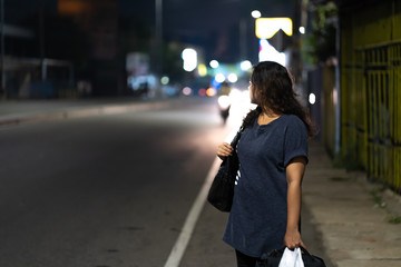 women alon walk in the road at night