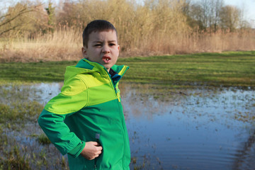 Boy, child, alone, standing by the lake, emotional portrait, close-up