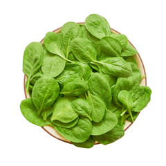 Fresh spinach leaves on white plate isolated over white background with clipping path. Healthy food concept. Top view