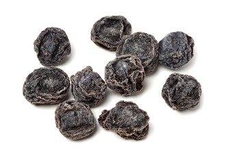 Dried black plums isolated on white background